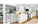 Bright kitchen featuring white cabinets, stainless steel appliances, and an adjacent bar area for entertaining at 5452 Tally Green Dr, Marietta, GA 30068