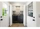 Convenient laundry room equipped with modern washer and dryer units and storage cabinets at 5452 Tally Green Dr, Marietta, GA 30068
