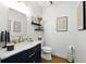 Elegant powder room with a navy vanity, gold hardware, and stylish decor at 5452 Tally Green Dr, Marietta, GA 30068