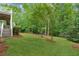 Spacious backyard with a slight hill and a view of the back of the house at 5705 Twelve Oaks Dr, Cumming, GA 30028
