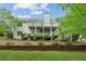 Large backyard with tiered wooden retaining walls on a sunny day at 5705 Twelve Oaks Dr, Cumming, GA 30028