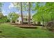 Spacious backyard featuring a lush lawn and two-story deck with a beautiful white house at 5705 Twelve Oaks Dr, Cumming, GA 30028