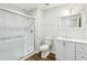 Modern bathroom with a shower, white vanity, and sleek fixtures offers a clean and functional space at 5705 Twelve Oaks Dr, Cumming, GA 30028