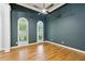 Bright bedroom with hardwood floors, a ceiling fan and natural light from two arched windows at 5705 Twelve Oaks Dr, Cumming, GA 30028