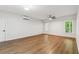 Airy bedroom features hardwood floors, a ceiling fan, and large windows providing ample natural light at 5705 Twelve Oaks Dr, Cumming, GA 30028