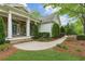 Charming exterior features a stone facade, elegant porch, and well-maintained landscaping at 5705 Twelve Oaks Dr, Cumming, GA 30028