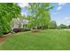 Expansive front yard with mature trees and lush landscaping of this beautiful home at 5705 Twelve Oaks Dr, Cumming, GA 30028