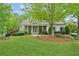 Charming single-Gathering home with well-manicured lawn, lush landscaping and inviting front porch at 5705 Twelve Oaks Dr, Cumming, GA 30028