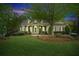 Charming single-Gathering home with well-manicured lawn, lush landscaping and inviting front porch at 5705 Twelve Oaks Dr, Cumming, GA 30028