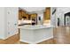 Kitchen island with white countertops and wooden cabinets at 5705 Twelve Oaks Dr, Cumming, GA 30028