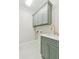Well-appointed laundry room boasts a green cabinetry, modern sink, and elegant gold faucet at 5705 Twelve Oaks Dr, Cumming, GA 30028