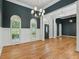 Spacious living area with hardwood floors, wainscoting, natural light from arched windows at 5705 Twelve Oaks Dr, Cumming, GA 30028