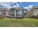 Lush backyard and the home's exterior featuring a deck, large windows and a well-kept lawn at 9843 Talisman Dr, Alpharetta, GA 30022