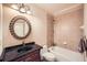 Bathroom features a decorative mirror, granite countertop, and a tiled tub and shower combo at 9843 Talisman Dr, Alpharetta, GA 30022