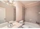 Bright bathroom featuring a shower-over-tub with tile surround and a large vanity with a framed mirror at 9843 Talisman Dr, Alpharetta, GA 30022