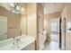 Bright bathroom featuring a framed mirror, a white vanity and a view to another room at 9843 Talisman Dr, Alpharetta, GA 30022