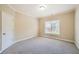 Neutral bedroom features plush carpeting, a window with blinds, and a door to the hallway at 9843 Talisman Dr, Alpharetta, GA 30022