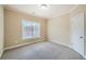 Neutral bedroom features plush carpeting, a window with blinds, and a door to the hallway at 9843 Talisman Dr, Alpharetta, GA 30022