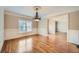 Formal dining room with hardwood floors, wainscoting, and a chandelier, perfect for entertaining guests at 9843 Talisman Dr, Alpharetta, GA 30022