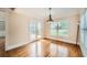 Bright dining room features wood floors, a classic chandelier, and access to the outdoor deck at 9843 Talisman Dr, Alpharetta, GA 30022