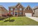 Charming brick home with a well-maintained lawn, landscaped garden, and a classic architectural design at 9843 Talisman Dr, Alpharetta, GA 30022