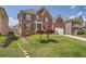Traditional brick home with a manicured lawn, charming trees, and a walkway leading to the side yard at 9843 Talisman Dr, Alpharetta, GA 30022