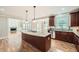 Modern kitchen featuring a granite island, dark cabinetry, and an open layout connecting to the living spaces at 9843 Talisman Dr, Alpharetta, GA 30022