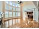 Spacious living room boasts soaring windows, a fireplace, and seamless flow to the kitchen at 9843 Talisman Dr, Alpharetta, GA 30022