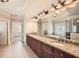 Bathroom with granite counters, -and- sinks, a large mirror, and a tub with shower at 9843 Talisman Dr, Alpharetta, GA 30022