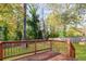 Back deck with a wooden railing, and a green yard at 1181 Mannbrook Dr, Stone Mountain, GA 30083