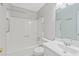 Bright bathroom featuring a shower and tub combination, with white tiling, sink, and toilet at 1181 Mannbrook Dr, Stone Mountain, GA 30083