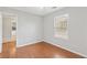 This bedroom features hardwood flooring and a window with natural light at 1181 Mannbrook Dr, Stone Mountain, GA 30083