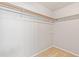Empty closet with one shelf and a wooden hanging rod at 1181 Mannbrook Dr, Stone Mountain, GA 30083