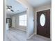 Inviting entryway featuring stylish wood-look floors and a view into the modern kitchen with stainless appliances at 1181 Mannbrook Dr, Stone Mountain, GA 30083