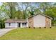 Charming single-story home featuring stone accents, light gray siding, and a welcoming front porch at 1181 Mannbrook Dr, Stone Mountain, GA 30083