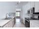 Well-equipped kitchen with stainless steel appliances and modern finishes; view to living area beyond at 1181 Mannbrook Dr, Stone Mountain, GA 30083