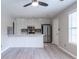 Open concept kitchen with stainless steel appliances, a center island, and sleek, modern flooring at 1181 Mannbrook Dr, Stone Mountain, GA 30083
