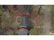 Aerial view outlining the property, highlighting the house, yard, and surrounding wooded area at 1907 Shalimar Ne Dr, Atlanta, GA 30345