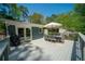 Outdoor deck area with table, chairs, grill, and lush greenery in the background at 1907 Shalimar Ne Dr, Atlanta, GA 30345
