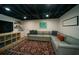 Finished basement with a cozy seating area, exposed ceiling, and unique decor at 1907 Shalimar Ne Dr, Atlanta, GA 30345