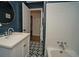 Bathroom with shiplap walls, patterned tile floor, and tiled shower/tub combo at 1907 Shalimar Ne Dr, Atlanta, GA 30345