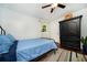 Bright bedroom with wood floors, ceiling fan, and a black armoire at 1907 Shalimar Ne Dr, Atlanta, GA 30345