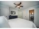 Bright bedroom with a large bed, hardwood floors, modern fan, and access to the bathroom at 1907 Shalimar Ne Dr, Atlanta, GA 30345
