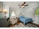 Comfortable bedroom featuring a ceiling fan, chair, and ample natural light at 1907 Shalimar Ne Dr, Atlanta, GA 30345