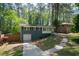 Exterior view of a home with brick and white accents, a driveway, and lush green landscaping at 1907 Shalimar Ne Dr, Atlanta, GA 30345