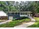 Charming home featuring a blue painted brick, white trim, and lush landscaping at 1907 Shalimar Ne Dr, Atlanta, GA 30345