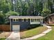 Charming single-story home with painted brick, white trim, an attached garage and a walkway up to the front door at 1907 Shalimar Ne Dr, Atlanta, GA 30345