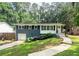 Charming one-story home featuring a combination of brick and white wood with inviting curb appeal and a lovely landscape at 1907 Shalimar Ne Dr, Atlanta, GA 30345