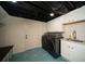 Finished laundry room featuring patterned floors, modern machines, and white cabinets at 1907 Shalimar Ne Dr, Atlanta, GA 30345