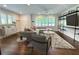 Sun-filled living room features shuttered windows, hardwood floors, modern shelving, and stylish furniture at 1907 Shalimar Ne Dr, Atlanta, GA 30345